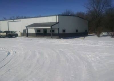 large white and grey steel building in winter